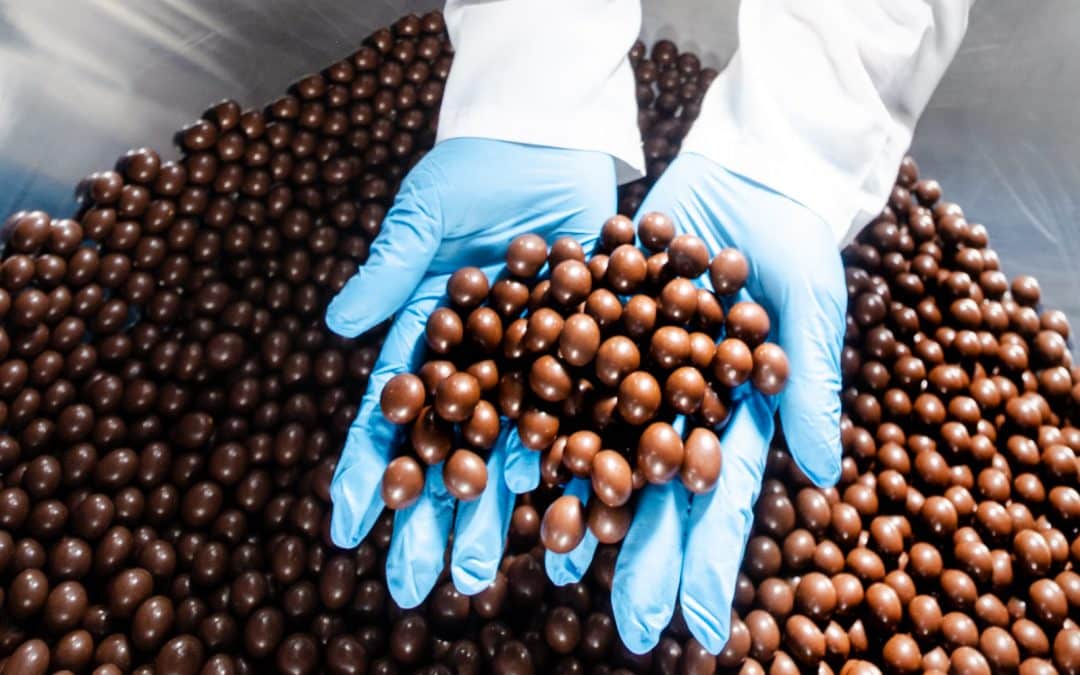 Person inspecting snack food in factory