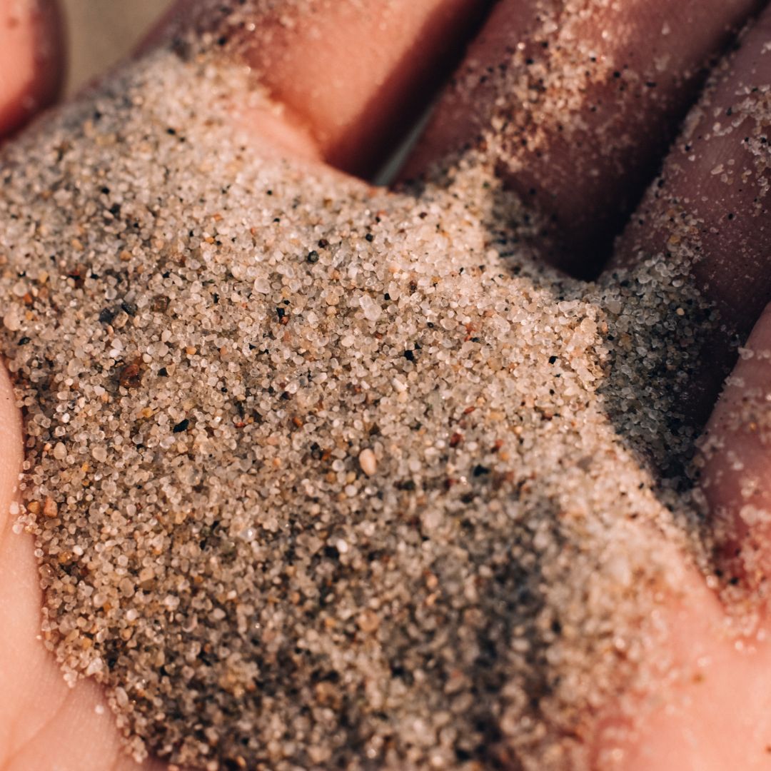 Close up of a hand holding sand