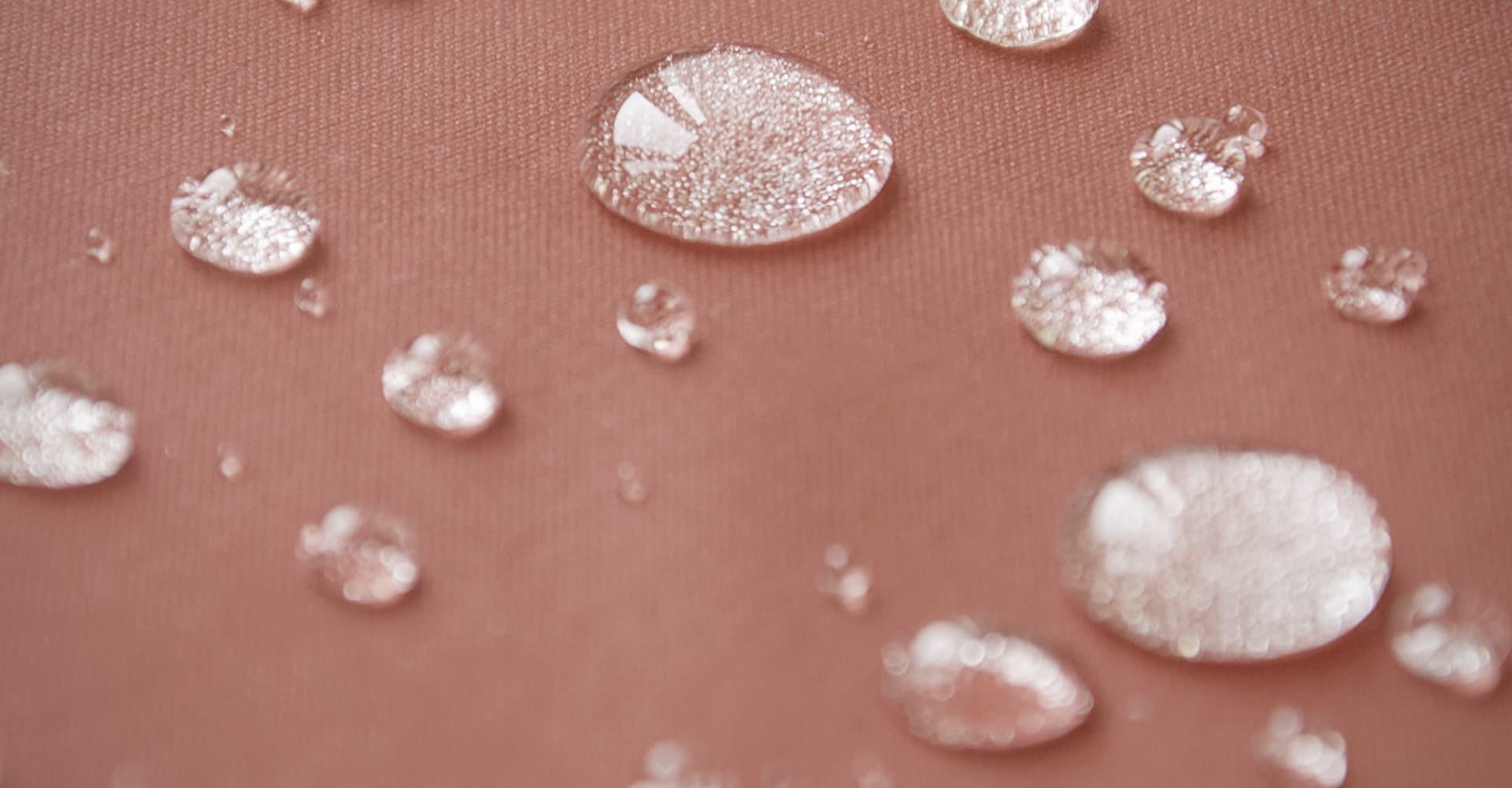 Water droplets on an orange background