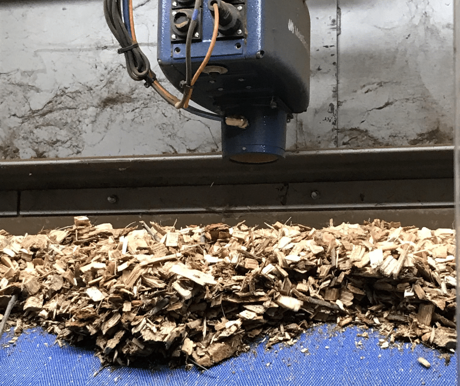 This image shows a MoistTech NIR-moisture sensor measuring the moisture in wood pellets.