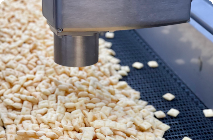 Snack food being measured for moisture on conveyor
