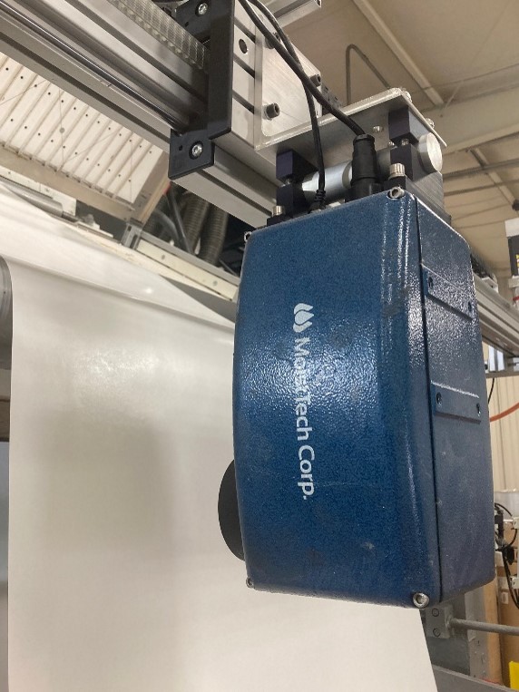 Close-up of MoistTech IR3000 sensor installed above an adhesive-coated substrate.