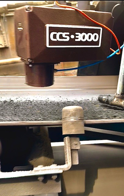 MoistTech CCS-3000 sensor measuring coal moisture on a conveyor belt